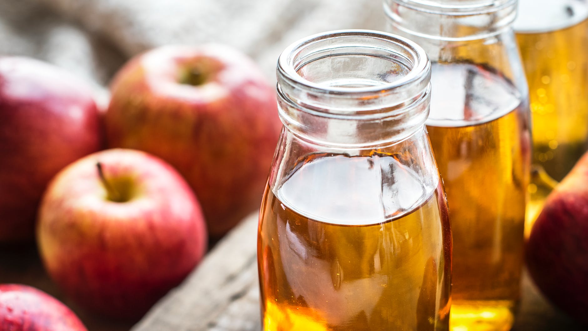 clear glass mason bottles with apple juice